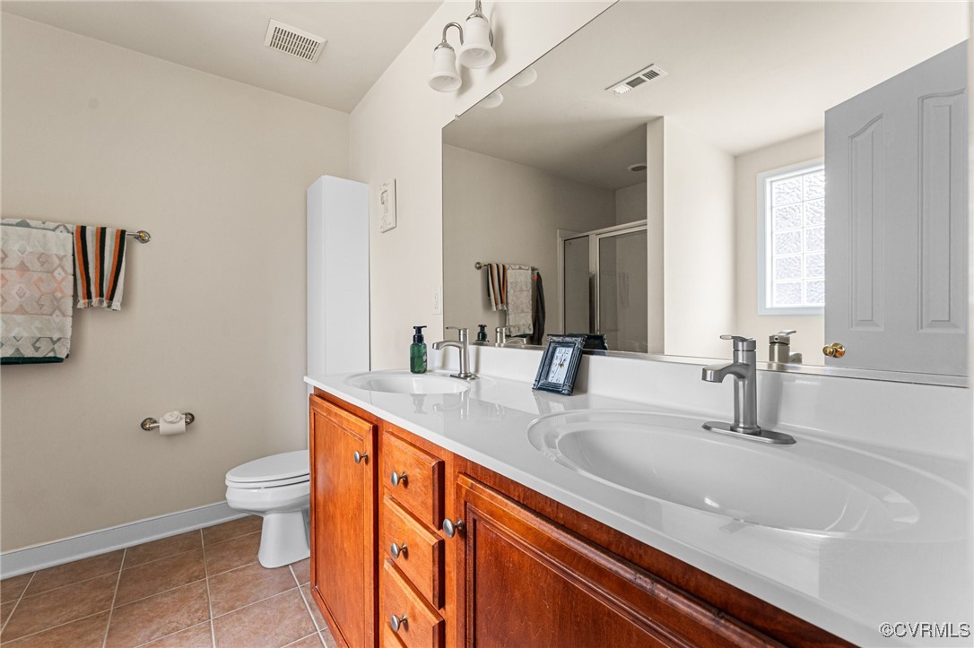 3321 Ceres Road Henrico, VA 23294 - Photo 18 of 38 a bathroom with a sink a toilet and a mirror