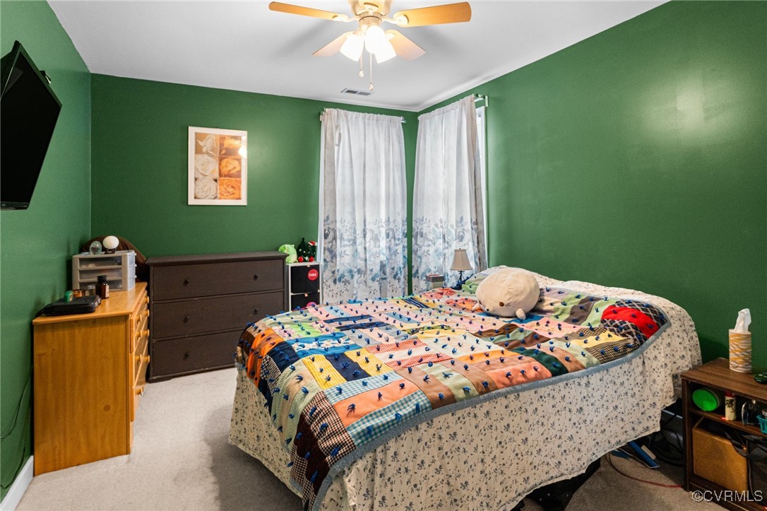 3321 Ceres Road Henrico, VA 23294 - Photo 20 of 38 a bedroom with a bed and a chandelier