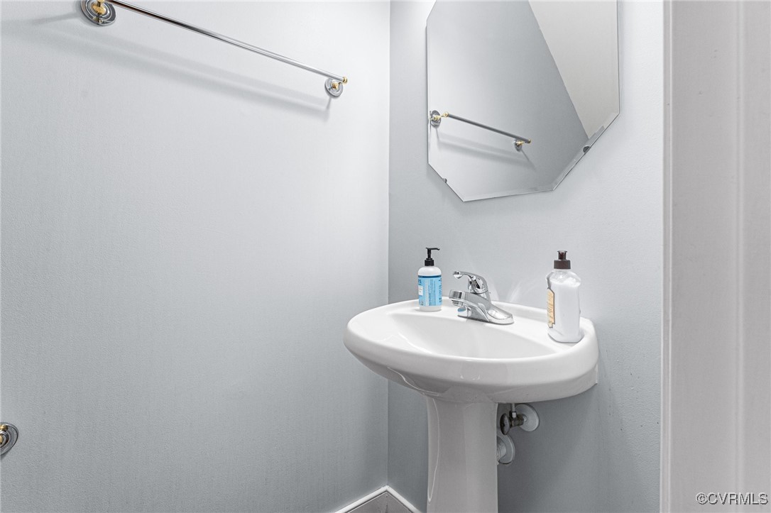 3321 Ceres Road Henrico, VA 23294 - Photo 29 of 38 a bathroom with a sink a mirror and shower