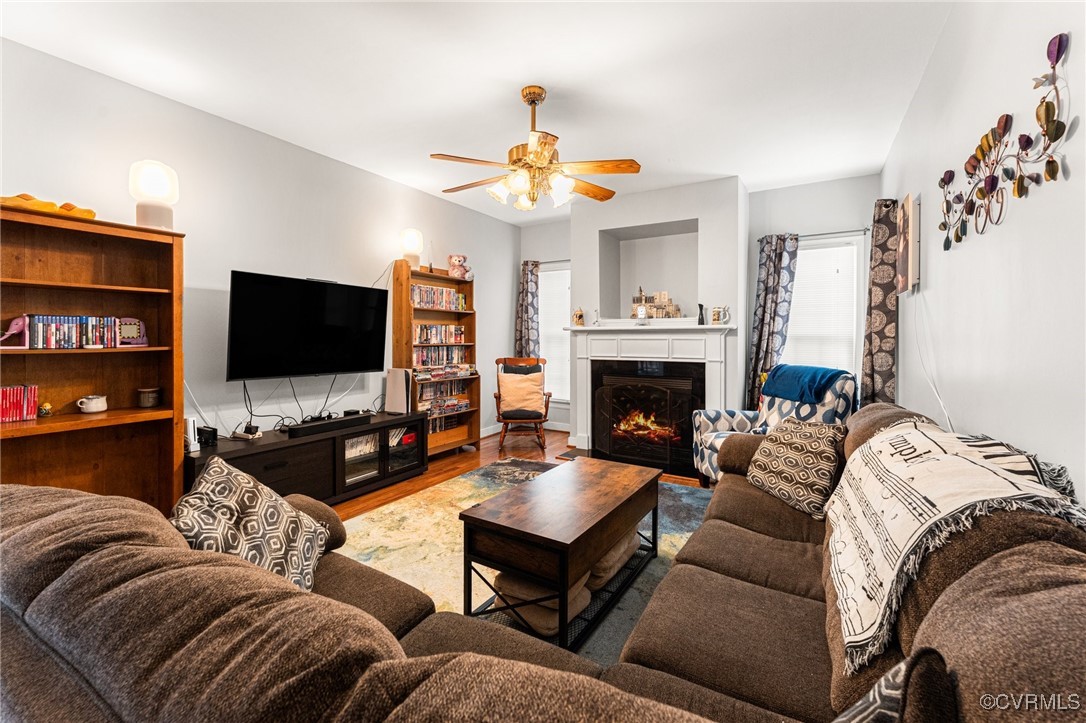 3321 Ceres Road Henrico, VA 23294 - Photo 7 of 38 a living room with furniture a flat screen tv and a fireplace