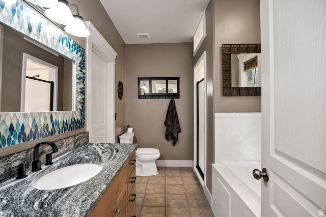 288 525 South Providence, UT 84332 - Photo 18 of 71 Bathroom featuring a wood-finish vanity with an undermount sink and a patterned stone countertop