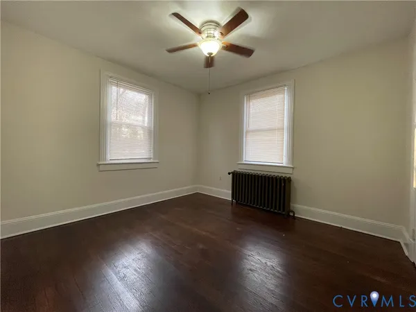 a view of a livingroom with wooden floor and a window