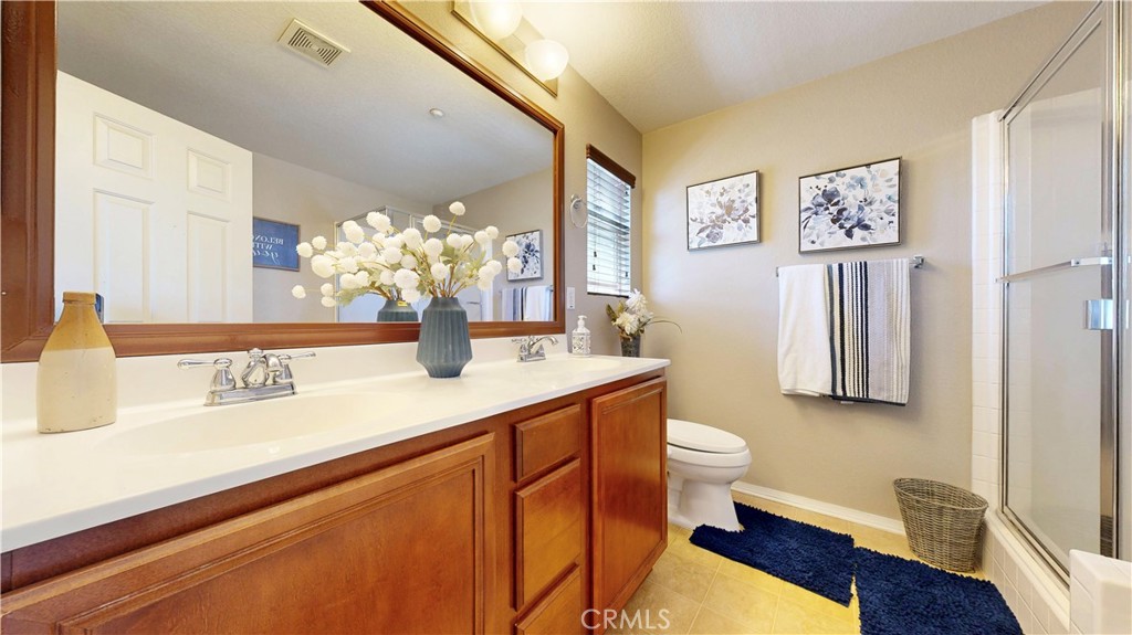 10375 Church Street, Unit 100 Rancho Cucamonga, CA 91730 - Photo 16 of 29 a bathroom with a sink a toilet and mirror