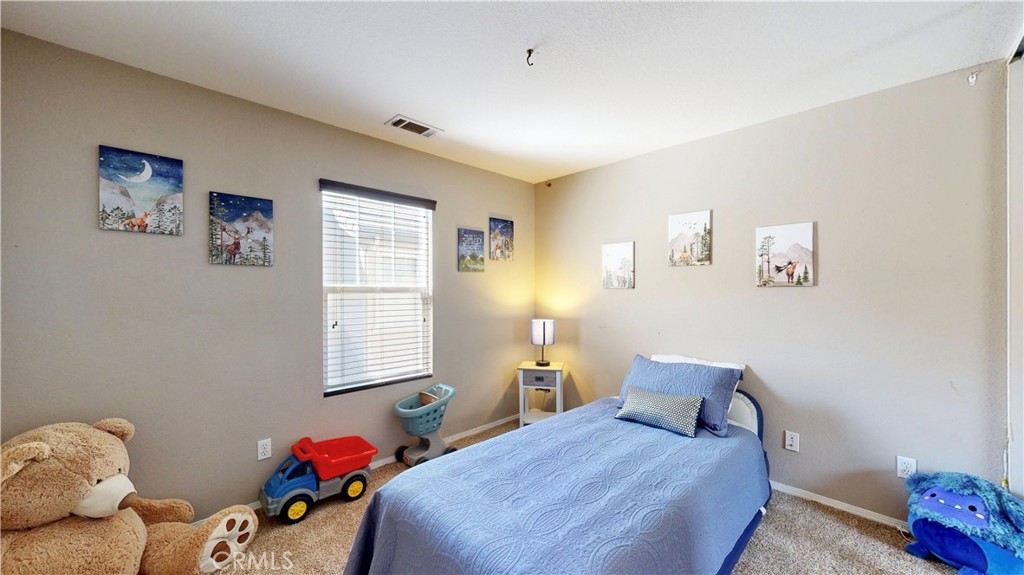 10375 Church Street, Unit 100 Rancho Cucamonga, CA 91730 - Photo 22 of 29 a bedroom with a bed and a window