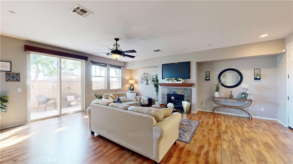 10375 Church Street, Unit 100 Rancho Cucamonga, CA 91730 - Photo 3 of 29 a living room with furniture a fireplace and a large window