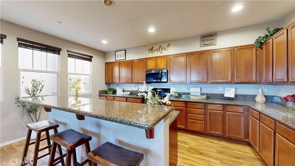 10375 Church Street, Unit 100 Rancho Cucamonga, CA 91730 - Photo 8 of 29 a kitchen with a sink a counter top space and stainless steel appliances