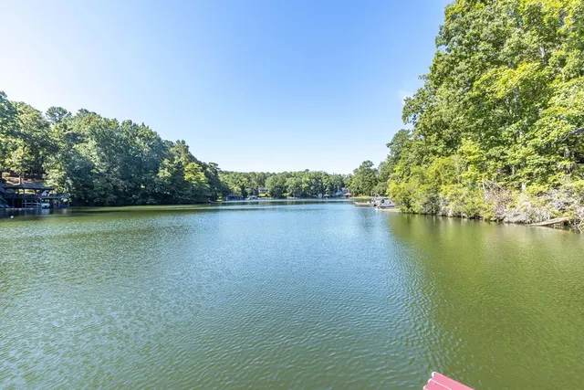 a view of a wooden deck with chairs and a yard