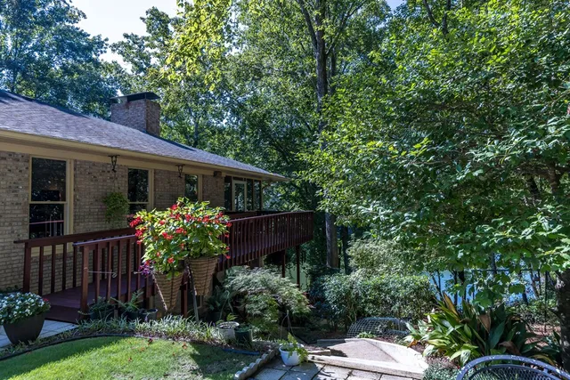 a view of house with yard and sitting area