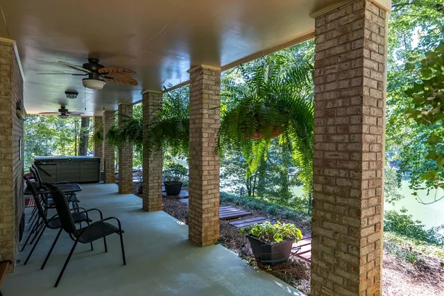 a view of a porch with chairs and potted plants