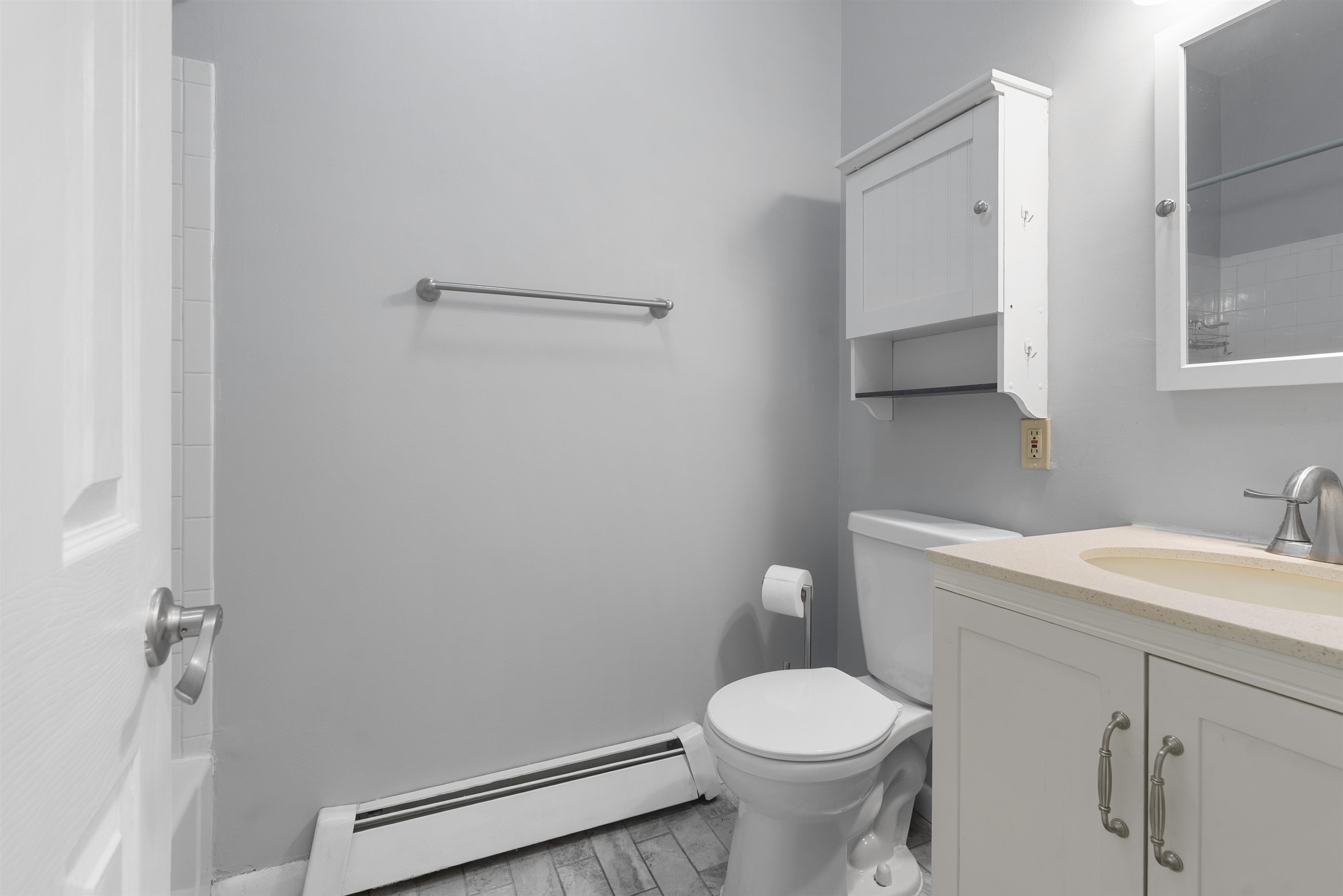 809 Park Avenue, Unit 9 Hoboken, NJ 07030 - Photo 18 of 30 a bathroom with a sink a toilet and a mirror