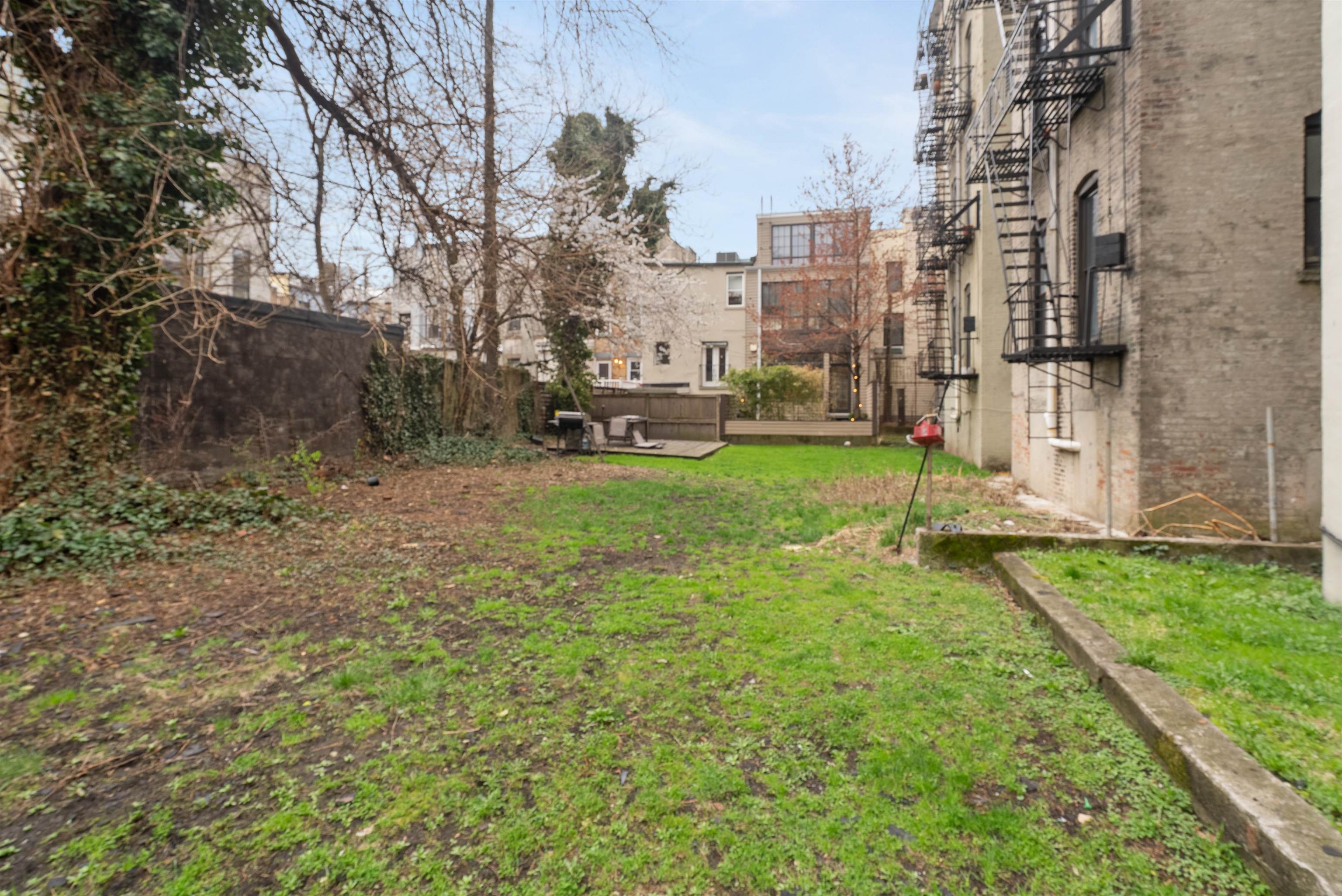 809 Park Avenue, Unit 9 Hoboken, NJ 07030 - Photo 28 of 30 a view of a city with tall buildings and a big yard