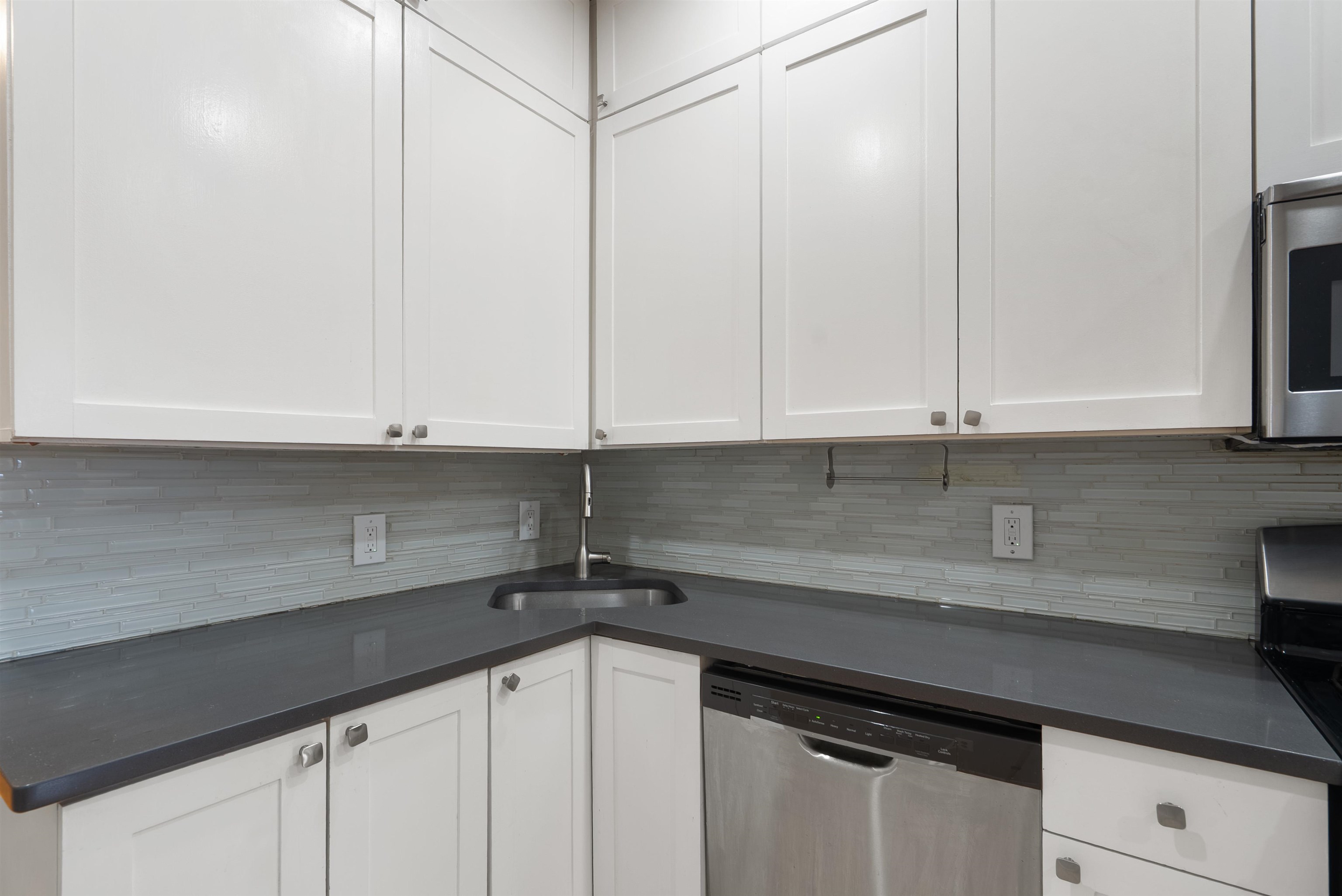 809 Park Avenue, Unit 9 Hoboken, NJ 07030 - Photo 9 of 30 a kitchen with a sink and cabinets