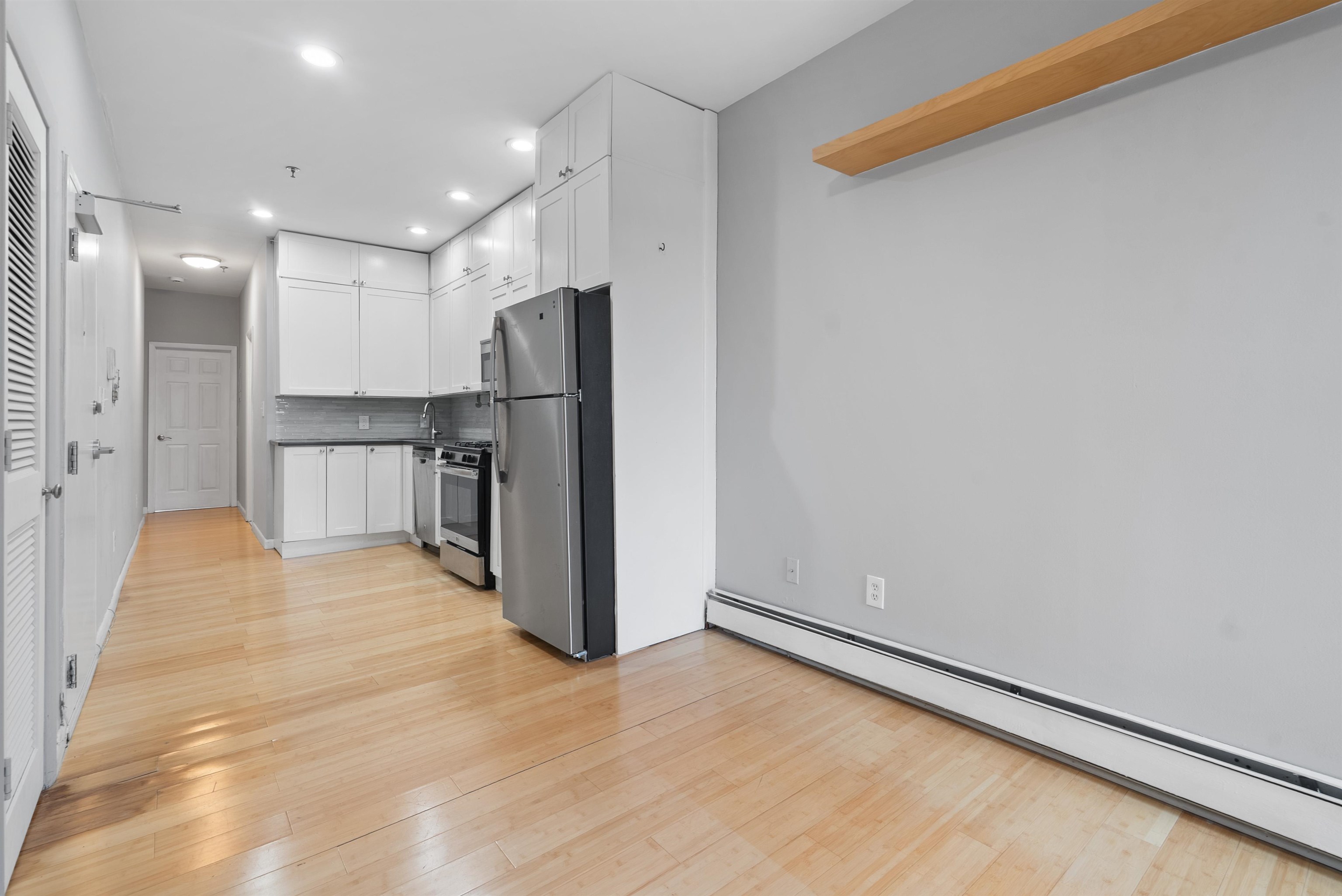 809 Park Avenue, Unit 9 Hoboken, NJ 07030 - Photo 10 of 30 a view of a kitchen with a refrigerator and a window