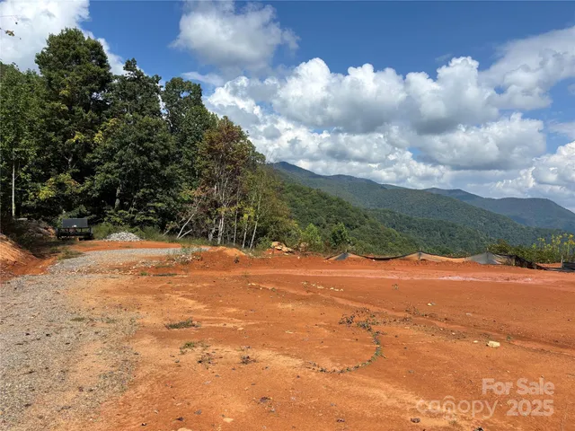 a view of a yard with wooden fence