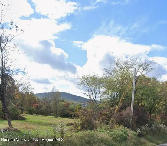 a view of a field of mountains in the background