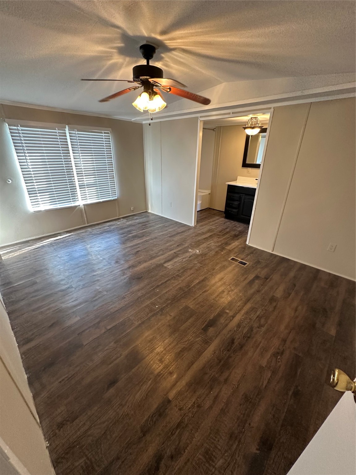 2021 North Battlebell Road, Unit 15 Highlands, TX 77562 - Photo 4 of 9 a view of empty room with wooden floor and fan