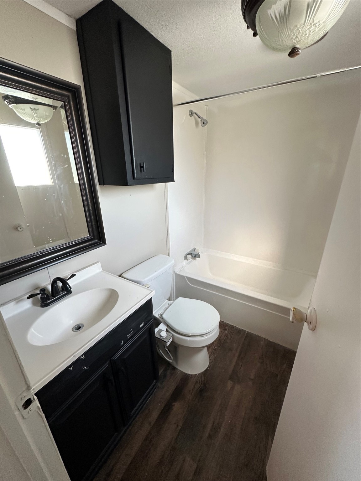 2021 North Battlebell Road, Unit 15 Highlands, TX 77562 - Photo 8 of 9 a bathroom with a sink vanity mirror and toilet