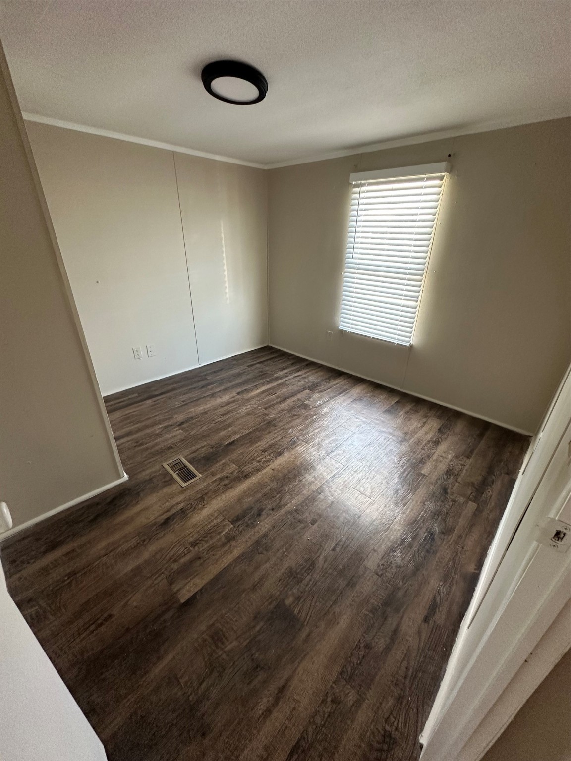 2021 North Battlebell Road, Unit 15 Highlands, TX 77562 - Photo 9 of 9 an empty room with wooden floor and windows
