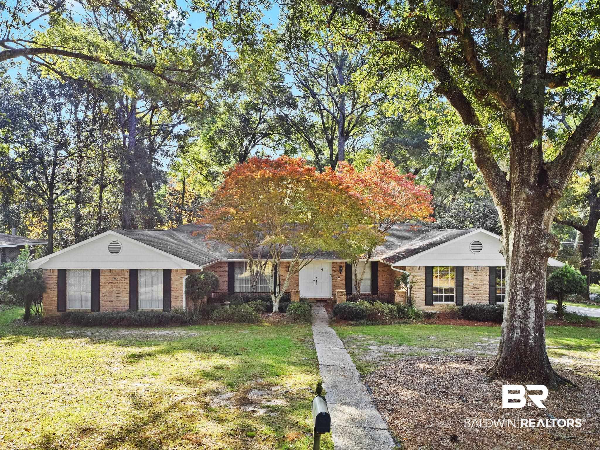 752 Evergreen Street Fairhope, AL 36532 - Photo 100 of 100 Ranch-style house featuring a front lawn, brick siding, view of scattered trees, and roof with shingles