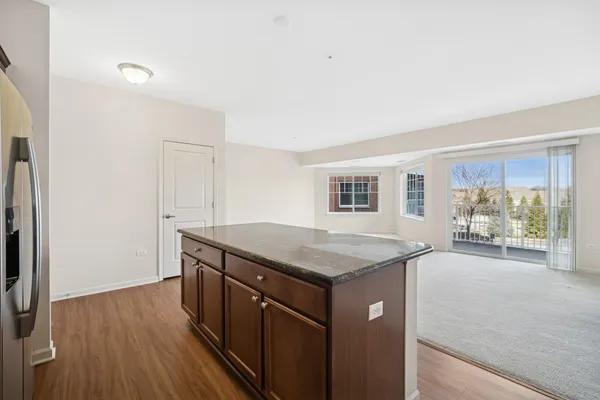 a kitchen with stainless steel appliances granite countertop a stove top oven a sink and a refrigerator
