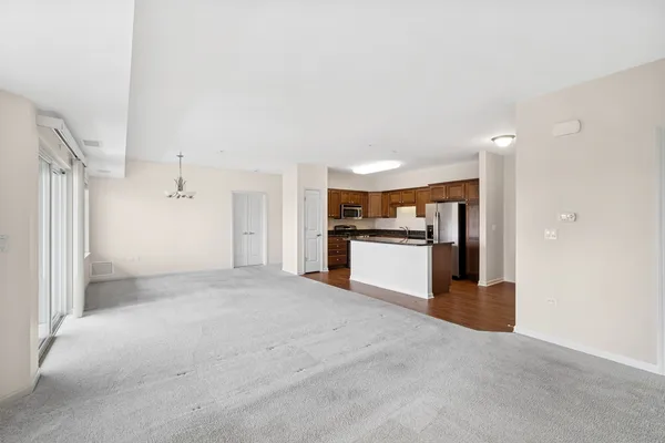 a view of kitchen with stainless steel appliances kitchen island a large counter top and a stove top oven