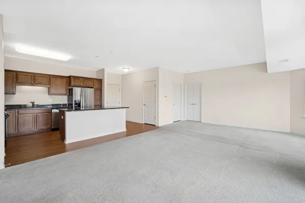 an empty room with windows and closet