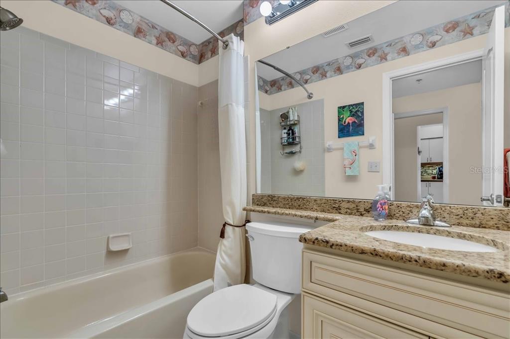 6713 Stone River Road, Unit 206 Bradenton, FL 34203 - Photo 21 of 58 a bathroom with a granite countertop sink toilet and shower