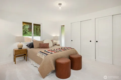a bedroom with furniture and a window