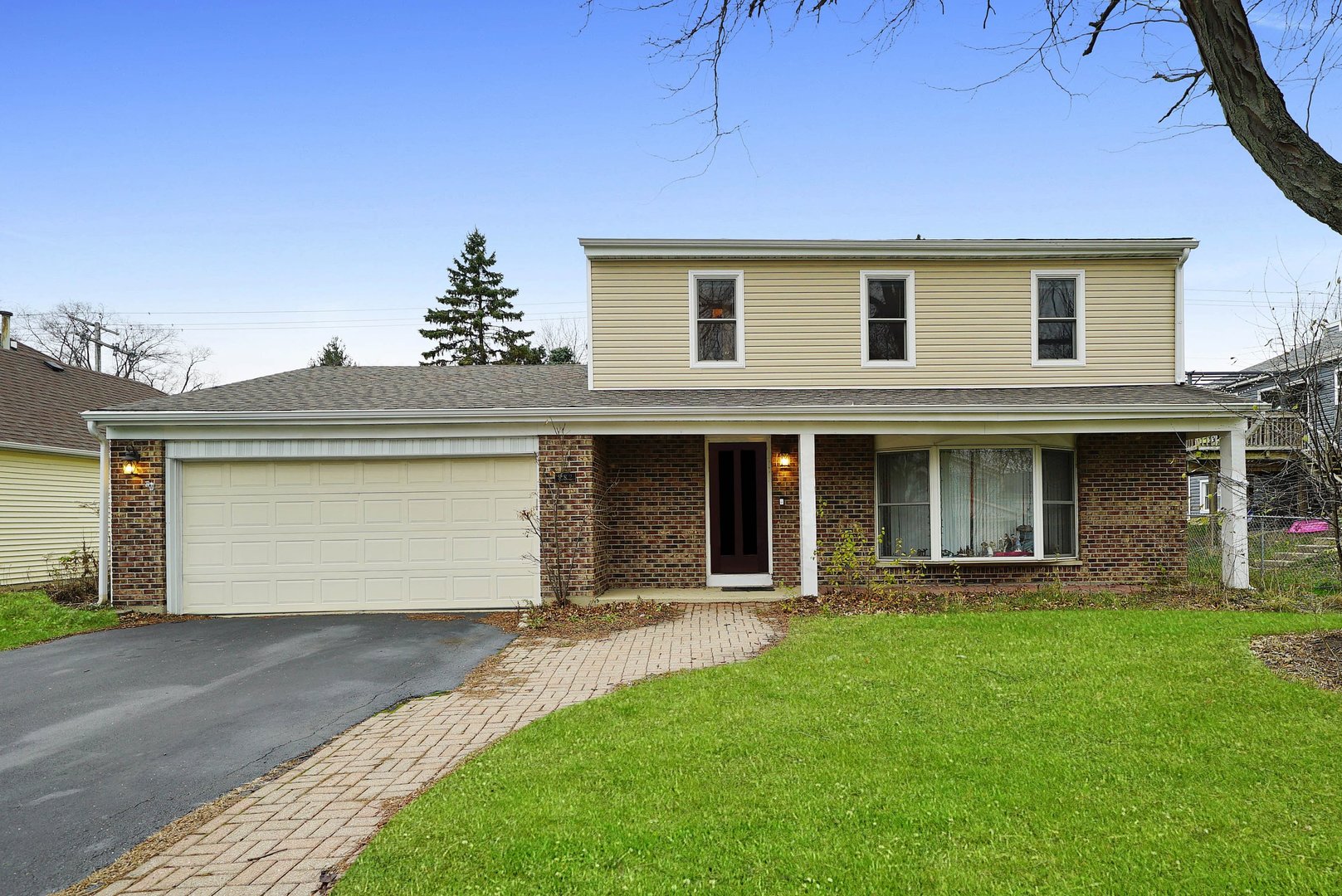 882 Pontiac Lane Carol Stream, IL 60188 - Photo 1 of 30 a front view of a house with a garden and yard