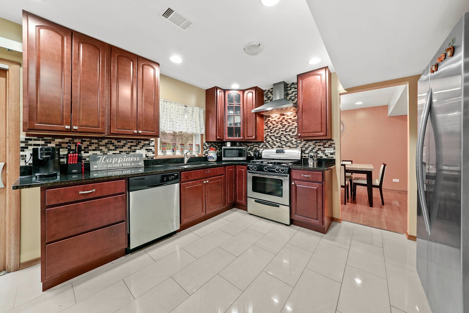882 Pontiac Lane Carol Stream, IL 60188 - Photo 12 of 30 a kitchen with stainless steel appliances granite countertop wooden cabinets a stove top oven a sink and dishwasher