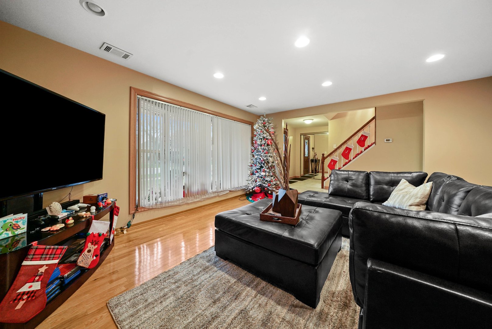 882 Pontiac Lane Carol Stream, IL 60188 - Photo 6 of 30 a living room with furniture and a flat screen tv