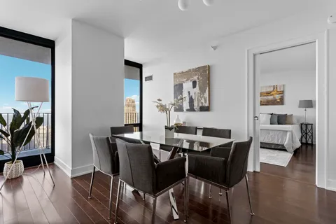 a view of a dining room with furniture and wooden floor