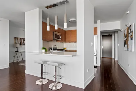 a kitchen with furniture and a refrigerator
