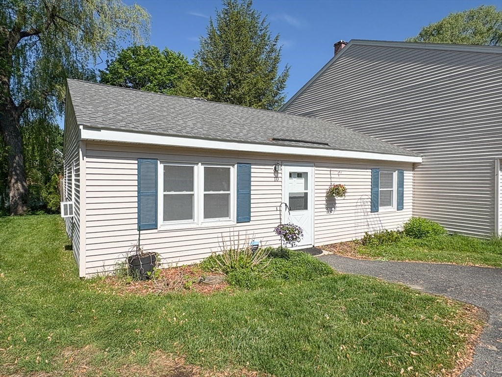 103 Main Street, Unit 10 Pepperell, MA 01463 - Photo 1 of 22 a front view of a house with garden