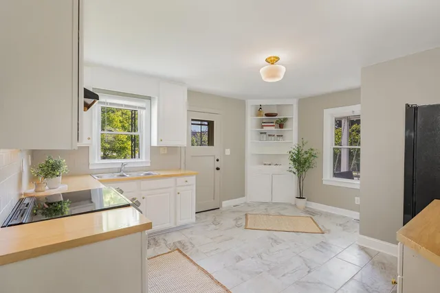 a spacious bathroom with a tub sink and mirror