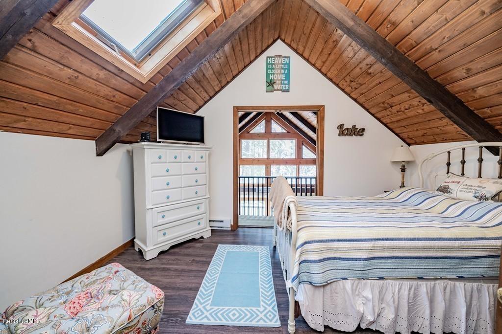 237 Slope Road Tolland, MA 01034 - Photo 22 of 40 a bedroom with a bed a dresser and a large window
