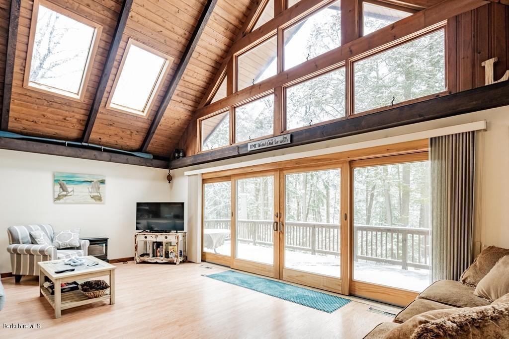 237 Slope Road Tolland, MA 01034 - Photo 5 of 40 a living room with furniture a flat screen tv and a large window