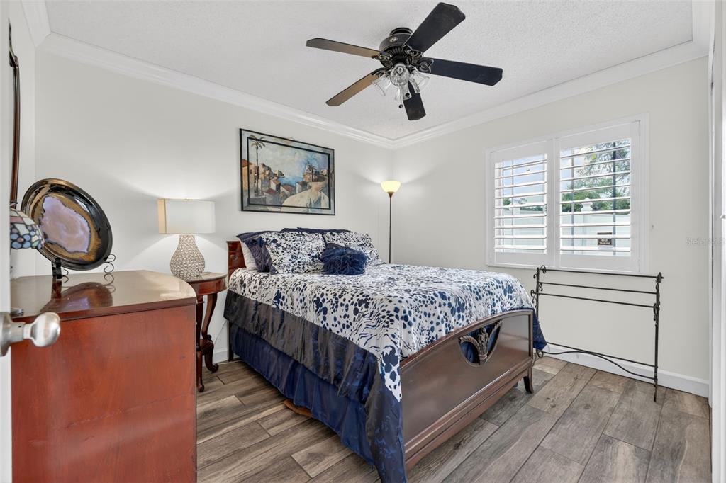 575 Tiberon Cove Road Longwood, FL 32750 - Photo 30 of 56 a bedroom with a bed a dresser and wooden floor