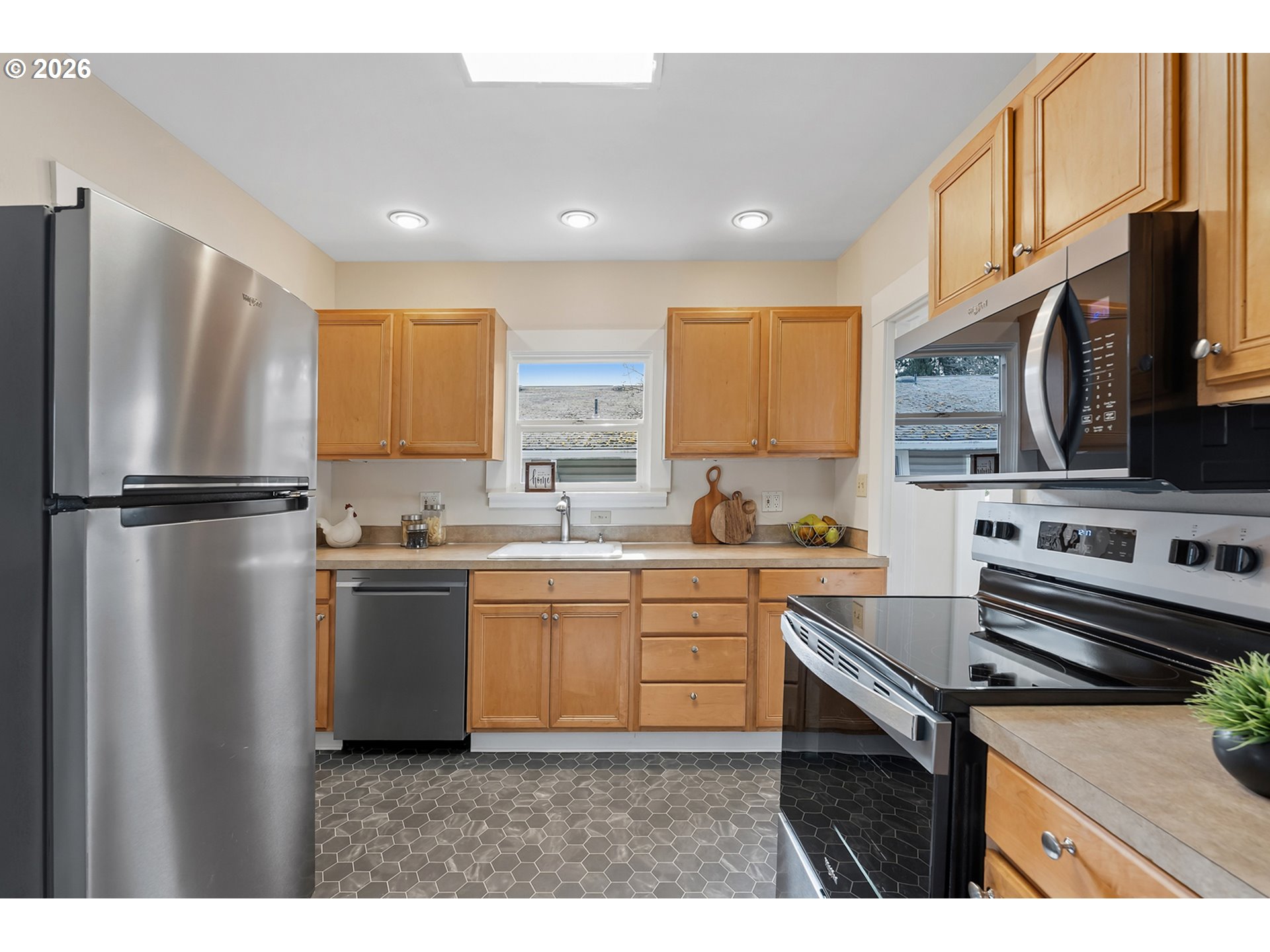 3134 Northeast 74th Avenue Portland, OR 97213 - Photo 13 of 42 a kitchen with stainless steel appliances a stove a sink and a refrigerator
