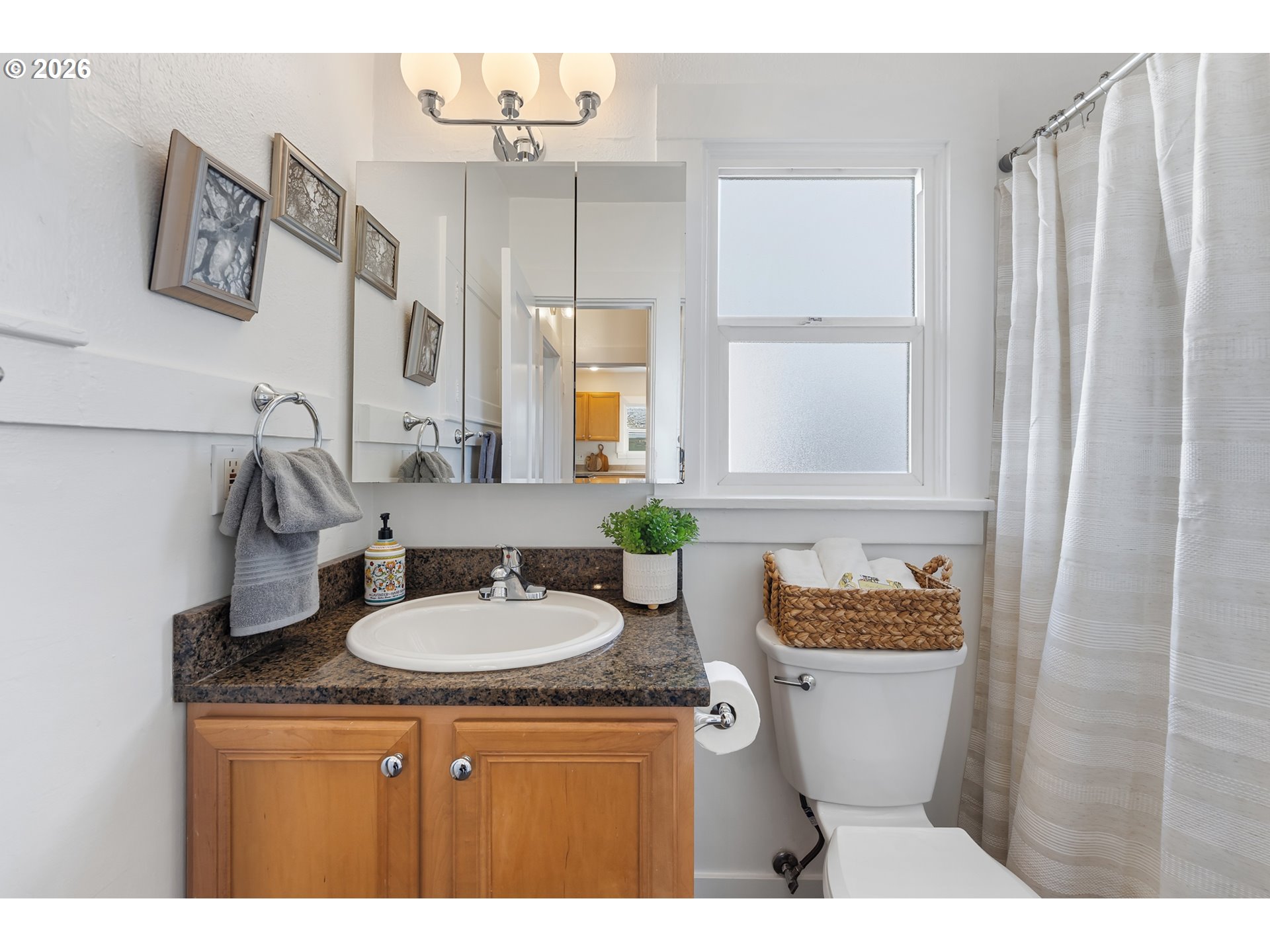3134 Northeast 74th Avenue Portland, OR 97213 - Photo 27 of 42 a bathroom with a granite countertop toilet sink and mirror