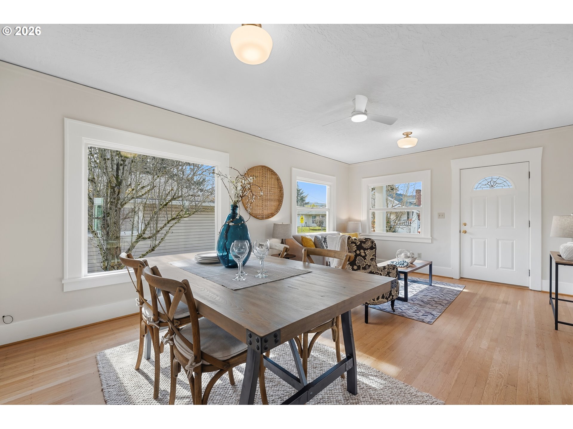 3134 Northeast 74th Avenue Portland, OR 97213 - Photo 10 of 42 a view of a dining room and livingroom with furniture wooden floor a rug a painting and a chandelier