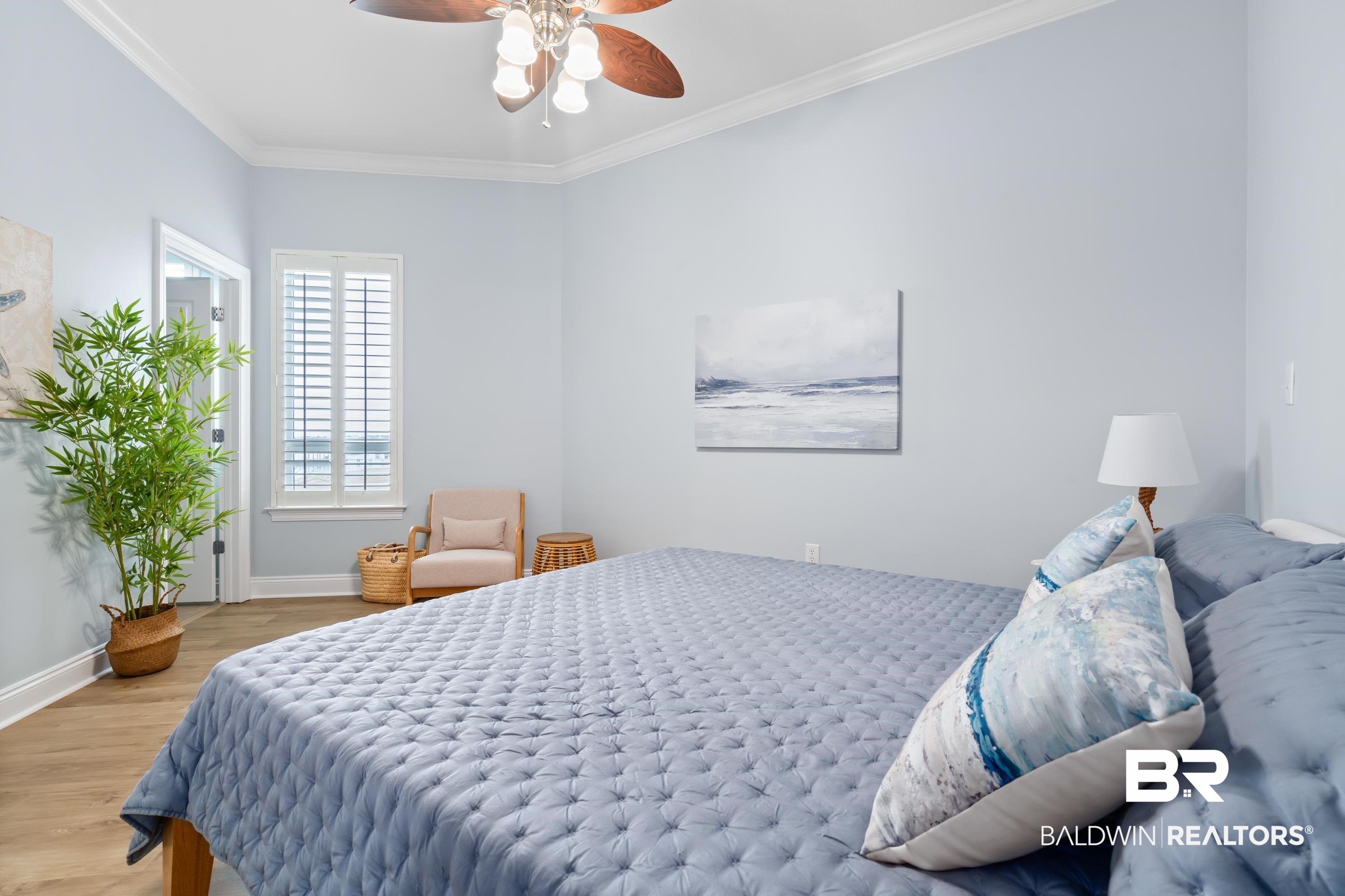 28250 Canal Road, Unit 101 Orange Beach, AL 36561 - Photo 16 of 34 Bedroom featuring ornamental molding, wood finished floors, a ceiling fan, and baseboards