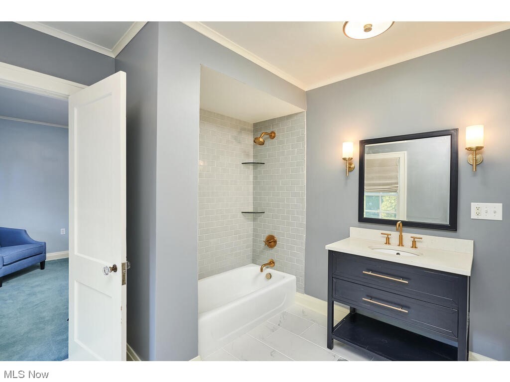 554 Merriman Road Akron, OH 44303 - Photo 19 of 35 Bathroom with ornamental molding, mirror, tiled shower / bath combo, light tile floors, and vanity