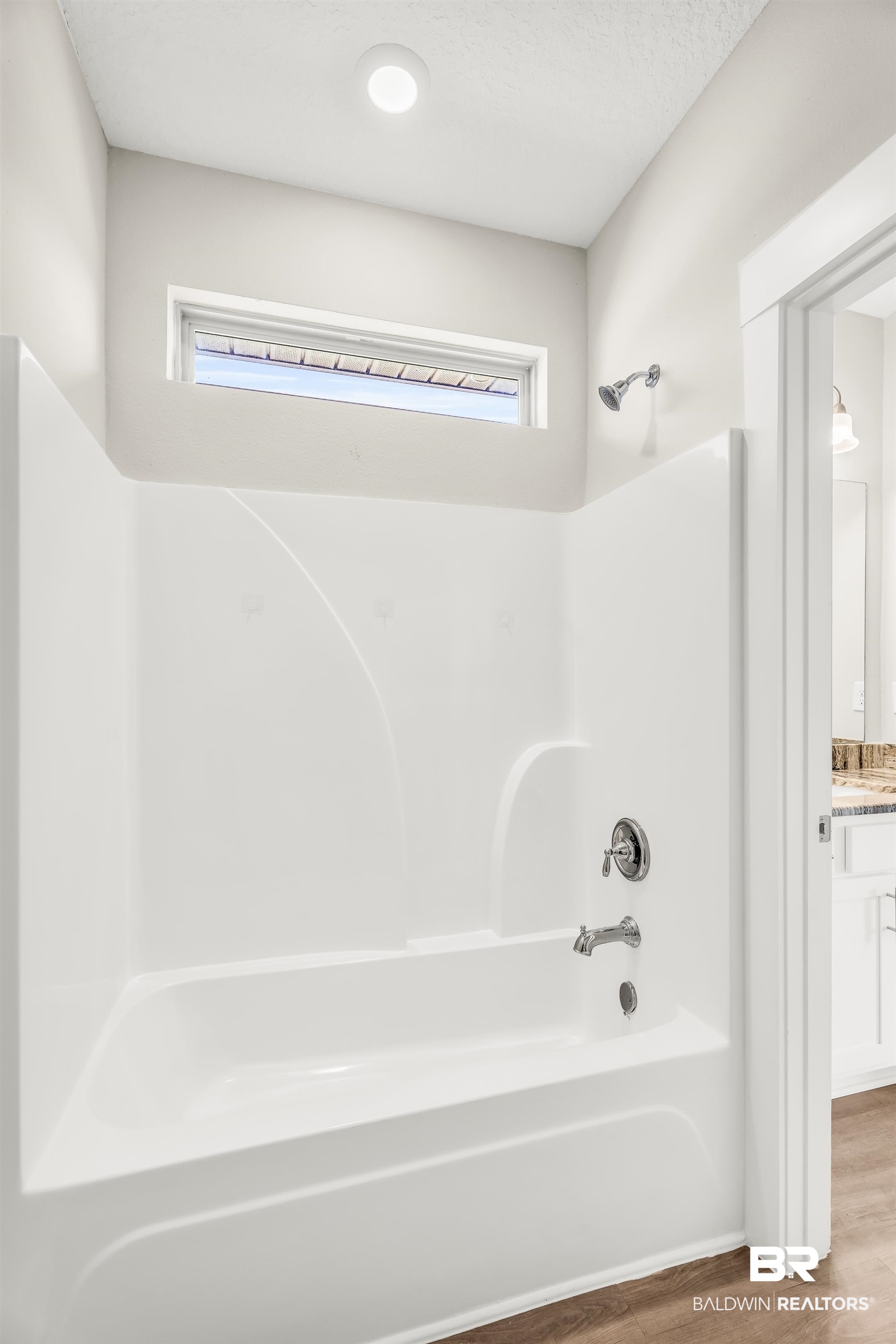 1720 Partridge Street Foley, AL 36535 - Photo 26 of 32 Bathroom featuring hardwood / wood-style floors, shower / bathtub combination, and a healthy amount of sunlight