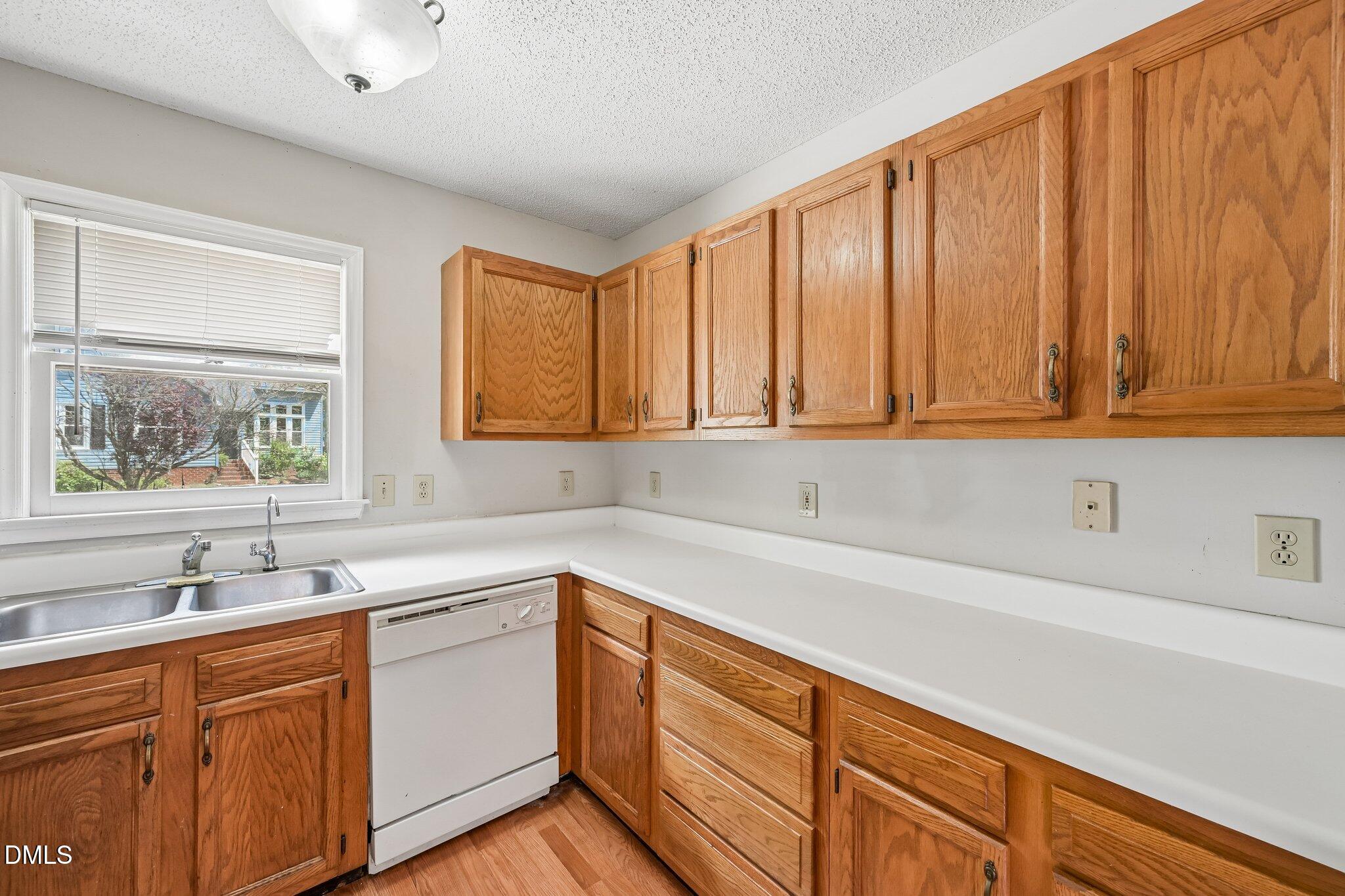 2800 West Jameson Road Raleigh, NC 27604 - Photo 10 of 24 a kitchen with a sink cabinets and window