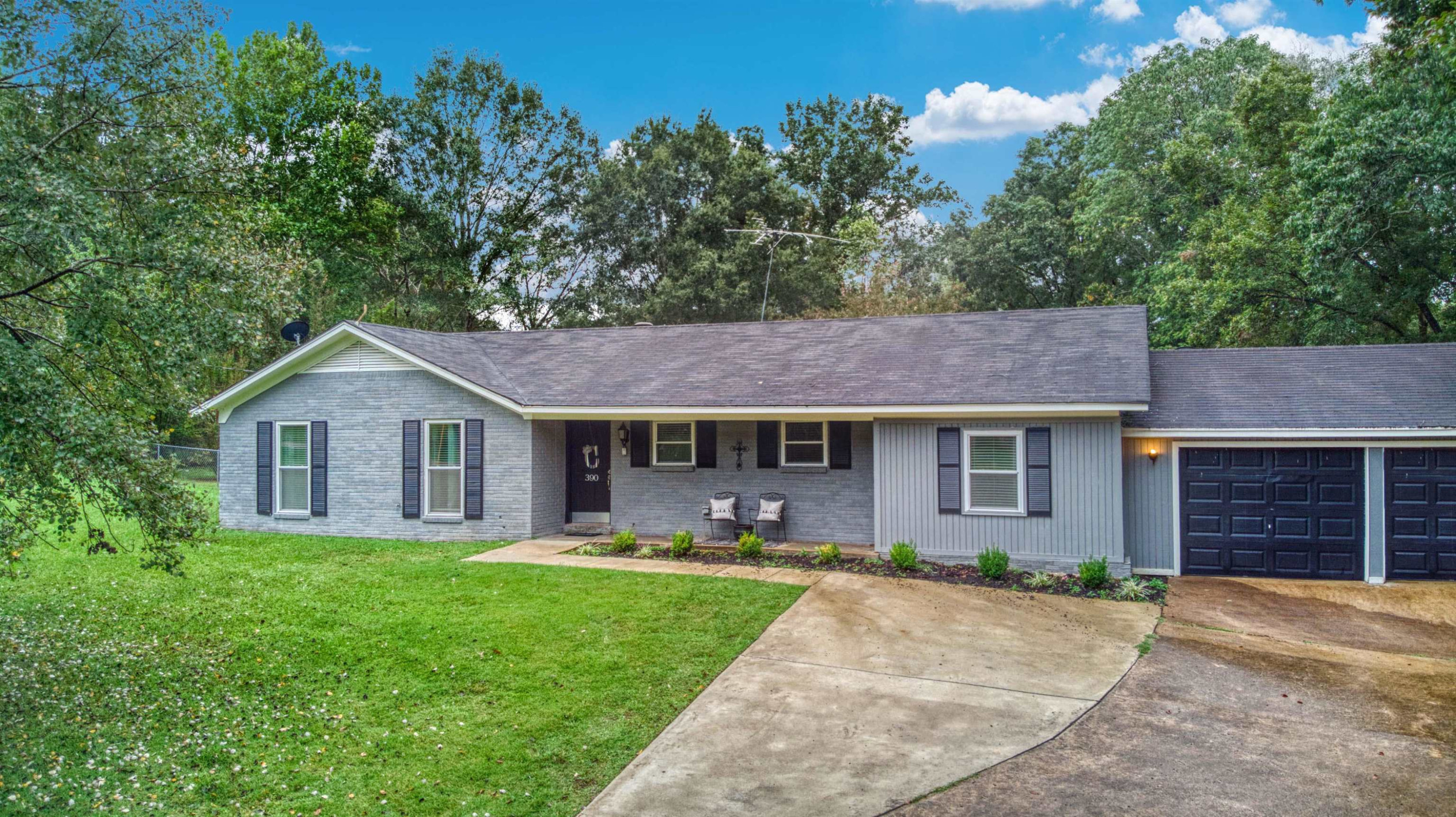 390 Lowery Road Medon, TN 38356 - Photo 1 of 24 a front view of a house with yard and green space