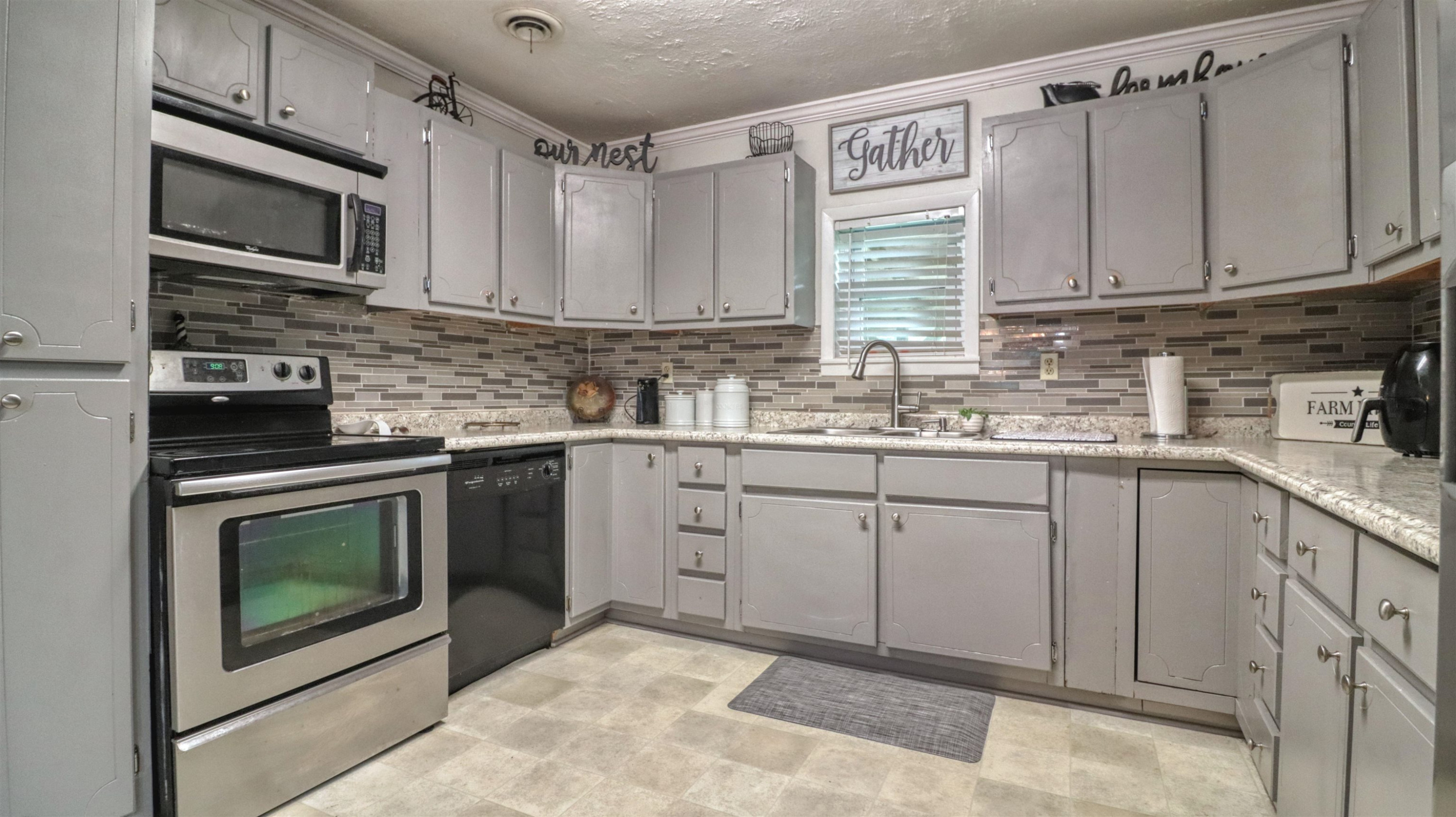 390 Lowery Road Medon, TN 38356 - Photo 13 of 24 a kitchen with stainless steel appliances granite countertop a sink stove and microwave