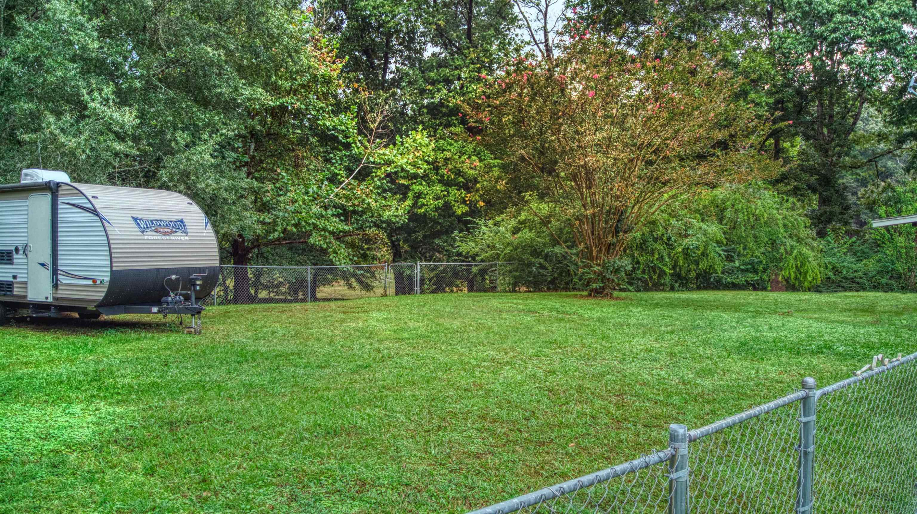390 Lowery Road Medon, TN 38356 - Photo 23 of 24 a backyard of a house with lots of plants and large trees