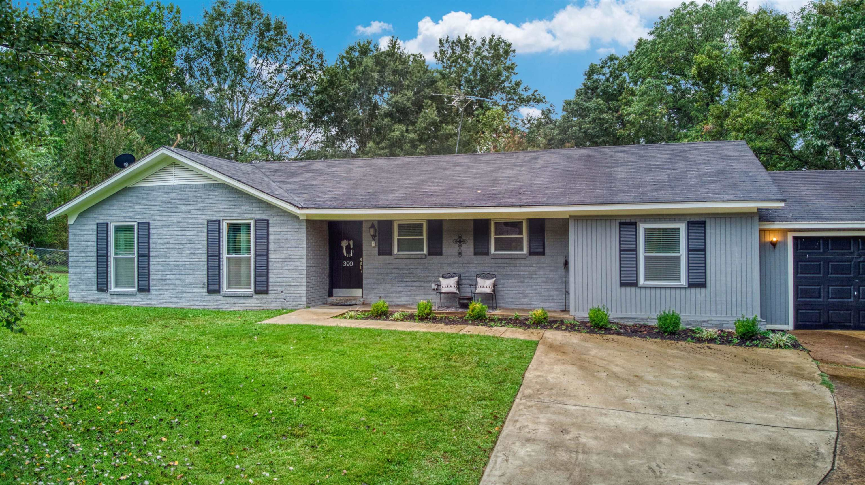 390 Lowery Road Medon, TN 38356 - Photo 24 of 24 a front view of a house with a garden and trees