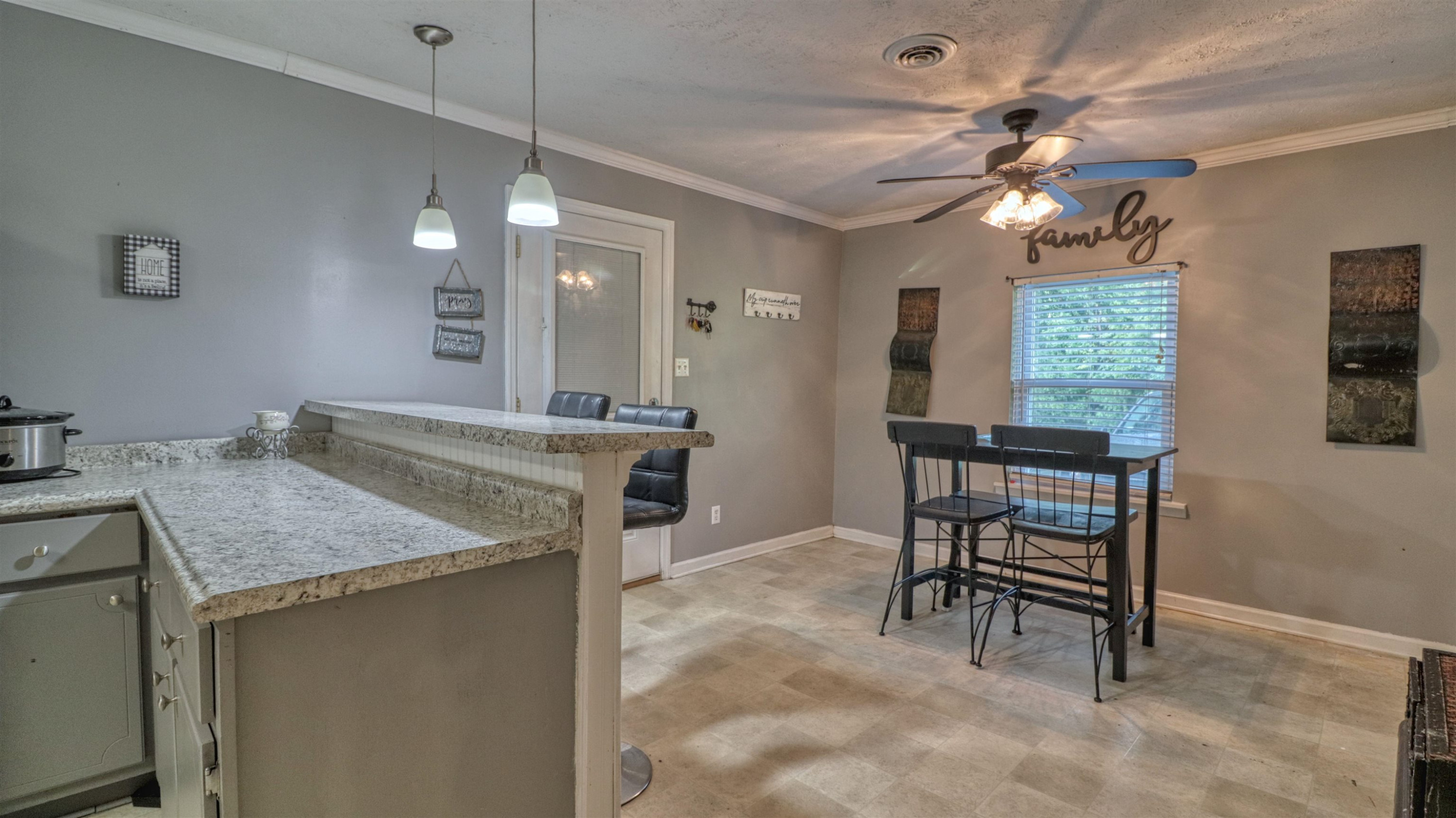 390 Lowery Road Medon, TN 38356 - Photo 9 of 24 a kitchen with a table chairs and a chandelier